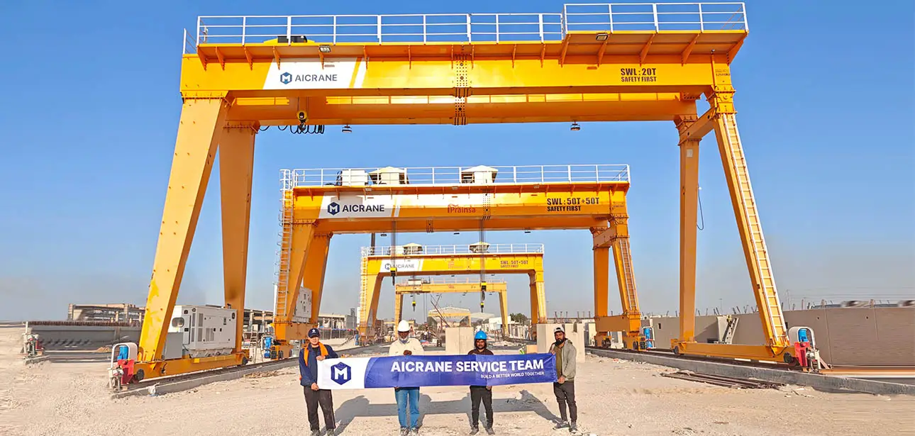 AICRANE engineers and Prainsa team standing in front of the installed 100t gantry crane in Saudi Arabia